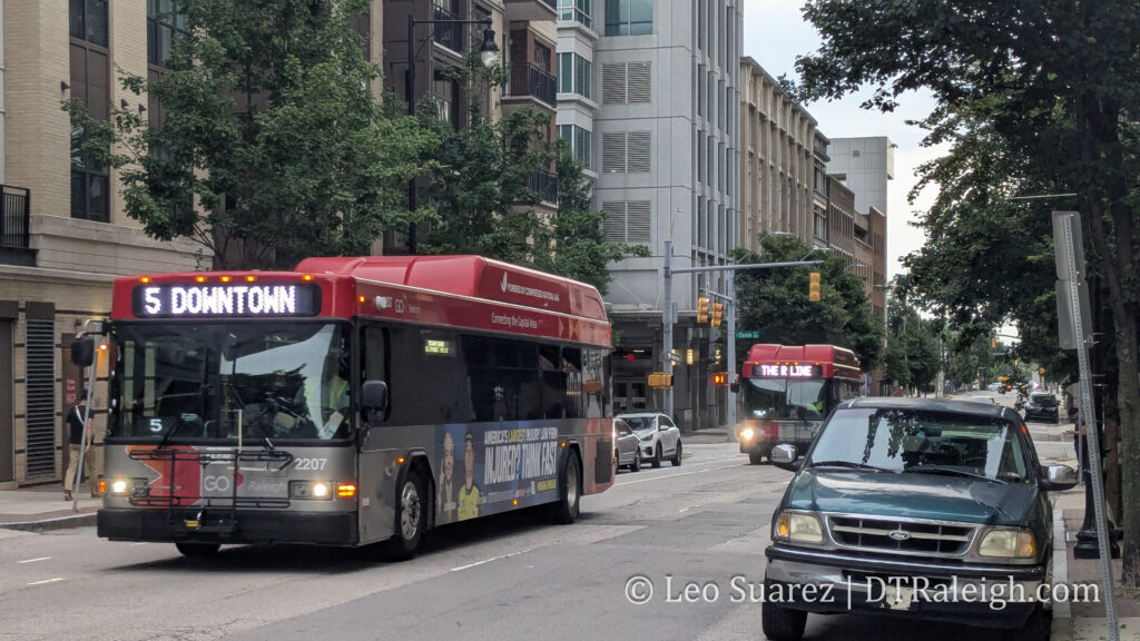 Photo of the R-Line following behind a bus serving the #5 GoRaleigh route.